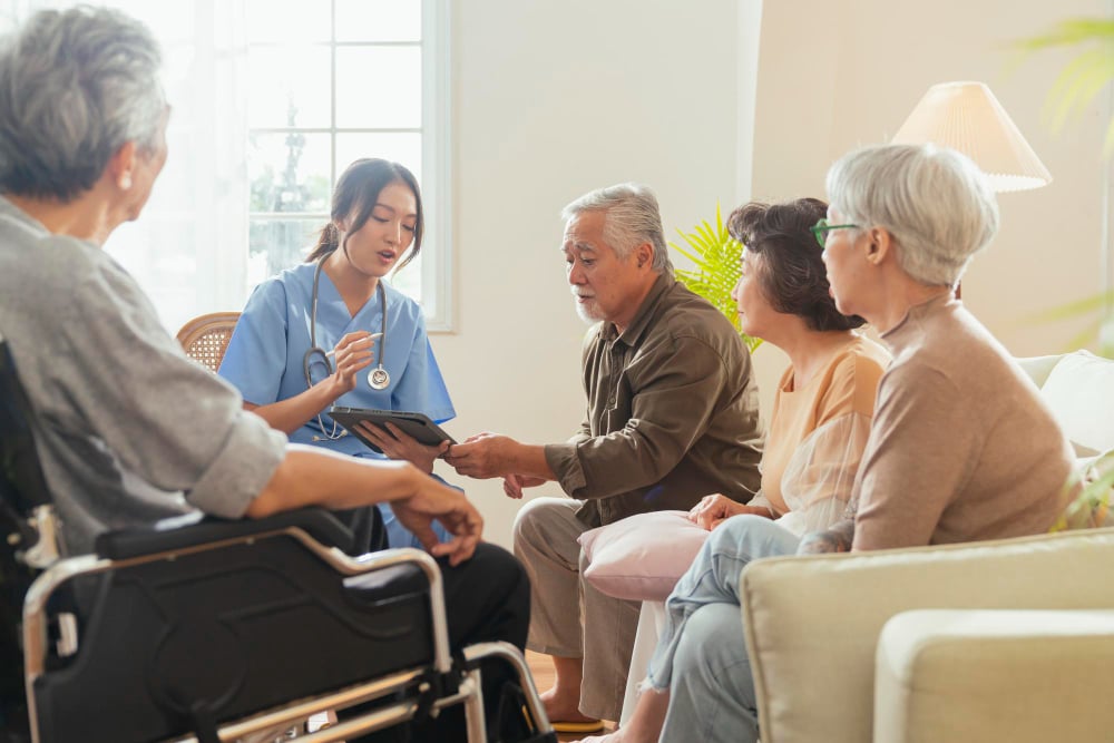 caregiver-nurse-having-health-checking-consult-living-areacaretakers-with-senior-couple-sitting-living-room-nursing-home